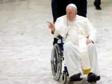 Pope Francis greets the crowd in a wheelchair at his general audience, Aug. 3, 2022.