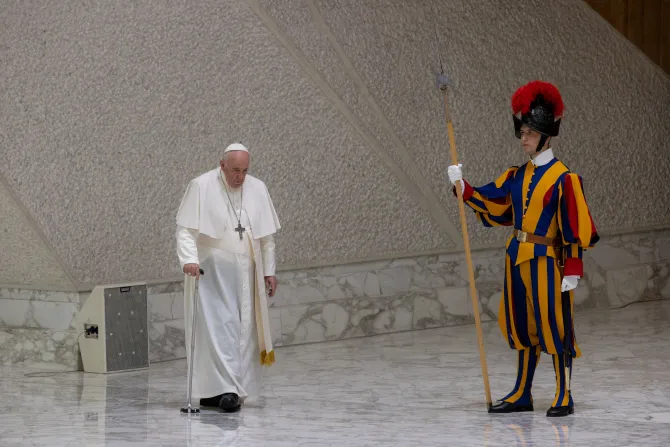 Pope Francis walked with a cane into Paul VI Hall for his Wednesday audience on Aug. 3, 2022.
