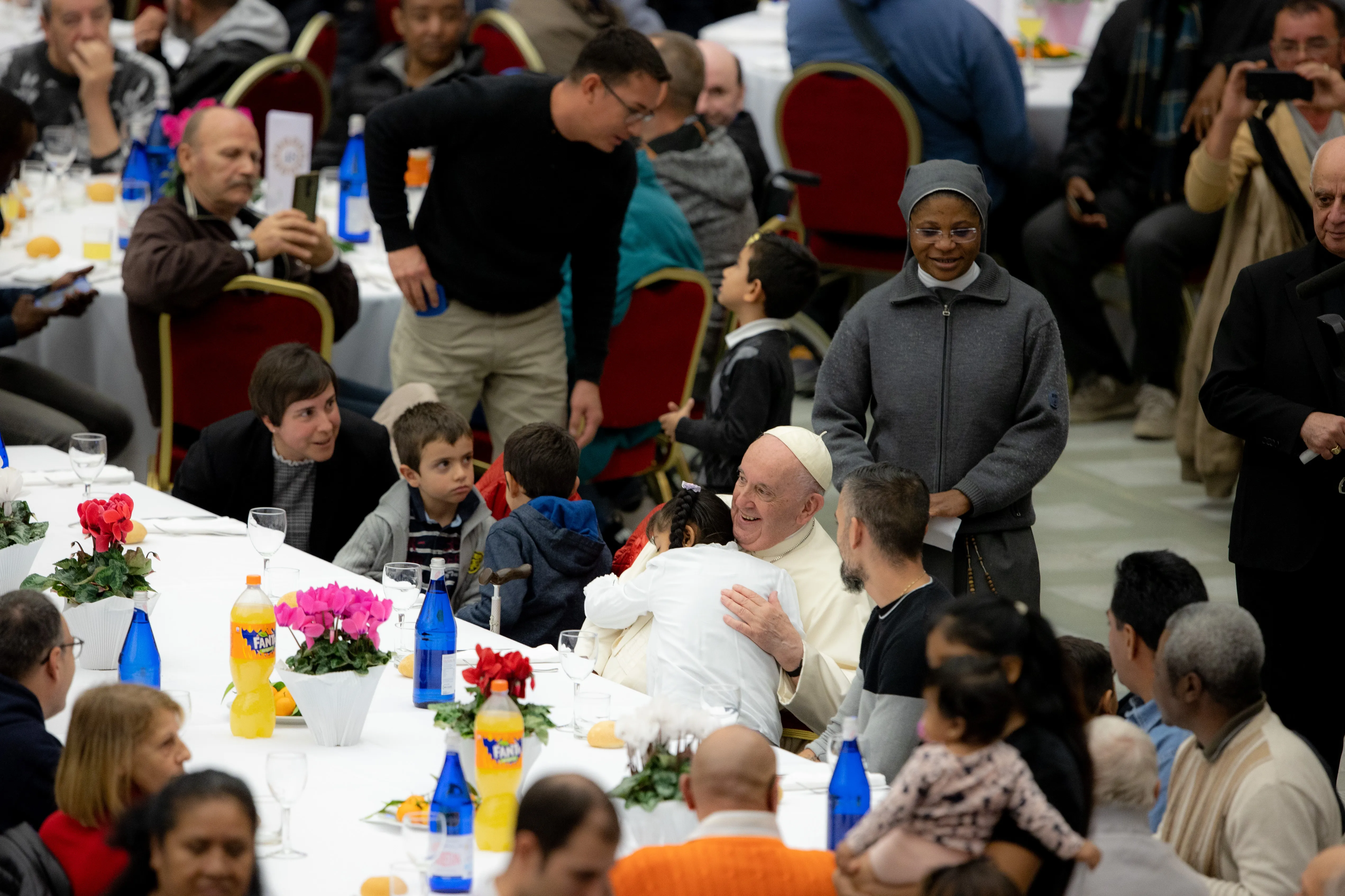 Pope Francis receives a hug from a child during lunch on the World Day of the Poor Nov. 13, 2022.?w=200&h=150