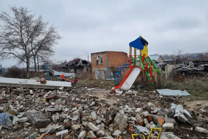 A playground destroyed by bombs among the ruins
