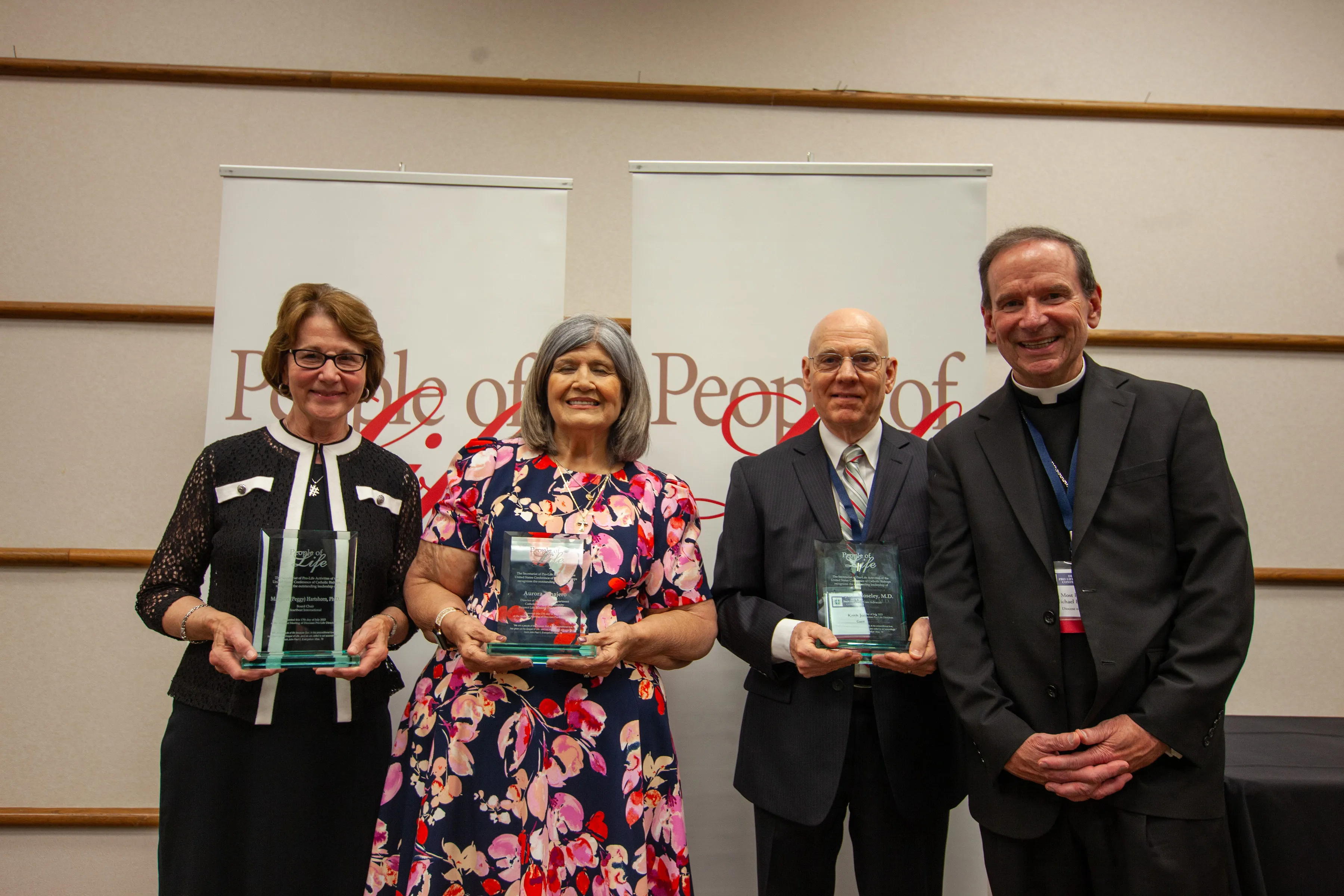 The U.S. Conference of Catholic Bishops on July 17, 2023, honored three champions of the pro-life cause at its People of Life awards during the annual Diocesan Pro-Life Leadership Conference in Toledo, Ohio. Pictured left to right are award recipients Margaret Hartshorn and Aurora Tinajero; Keith Moseley, husband of Kathryn Moseley, who passed away in June and received the award posthumously; and Bishop Michael Burbidge, chairman of the USCCB Committee on Pro-Life Activities.?w=200&h=150