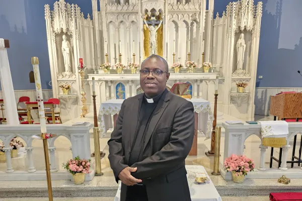 Father Mark Thomas Ameh in front of the high altar of Sts. Martha, Mary, and Lazarus Parish in Chicago. Credit: Courtesy of Father Mark Thomas Ameh