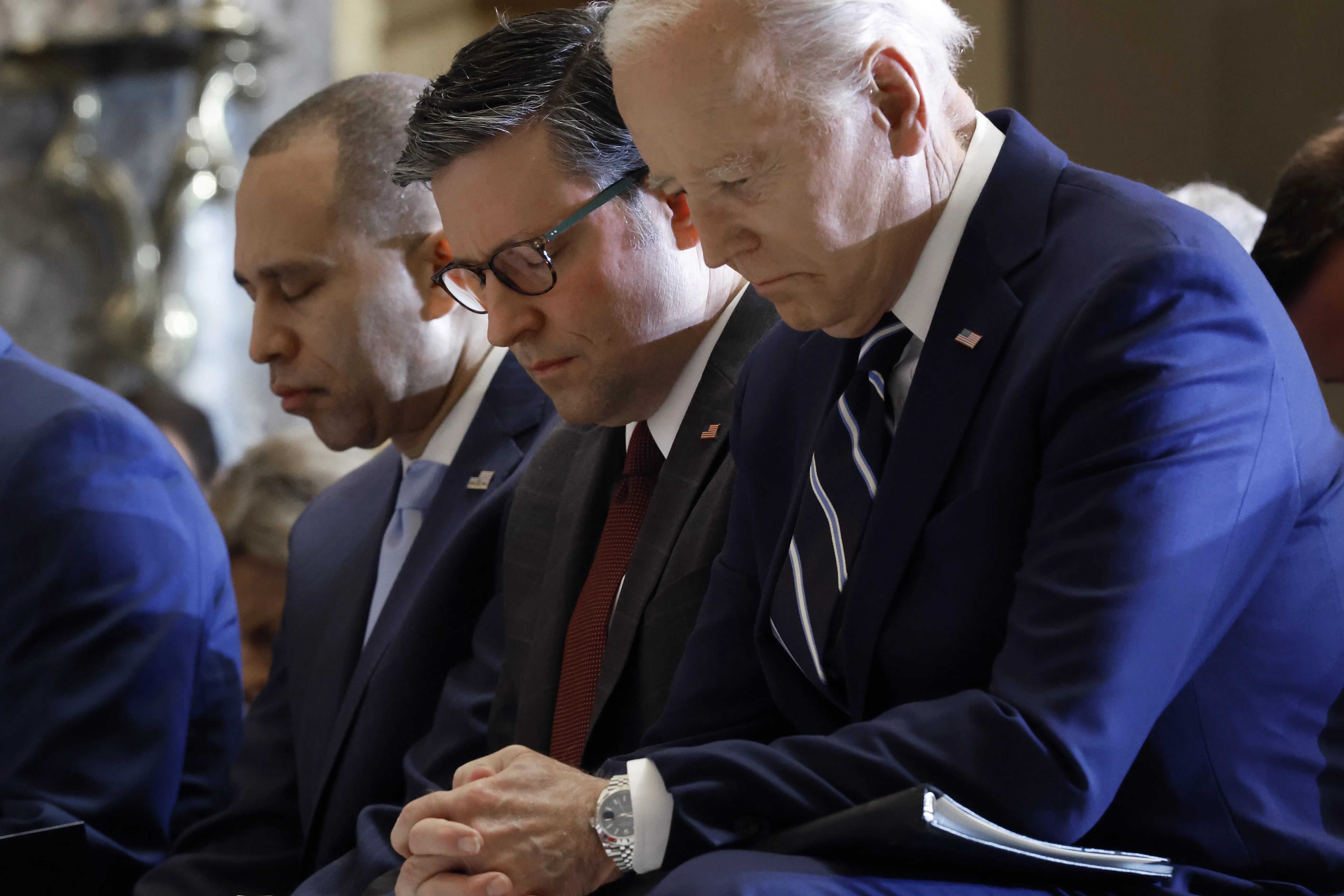 U.S. President Joe Biden, Speaker of the House Mike Johnson, and House Minority Leader Hakeem Jeffries bow their heads during the National Prayer Breakfast held in the U.S. Capitol’s Statuary Hall on Feb. 1, 2024.?w=200&h=150