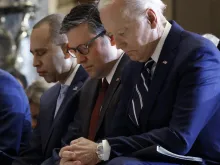 U.S. President Joe Biden, Speaker of the House Mike Johnson, and House Minority Leader Hakeem Jeffries bow their heads during the National Prayer Breakfast held in the U.S. Capitol’s Statuary Hall on Feb. 1, 2024.
