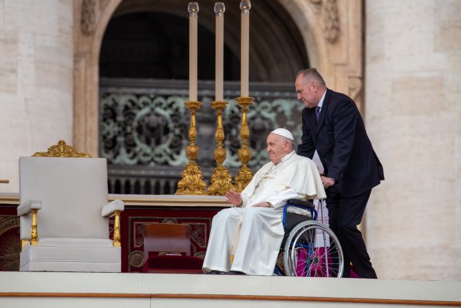 Pope Francis arrives at Palm Sunday Mass in a wheelchair.
