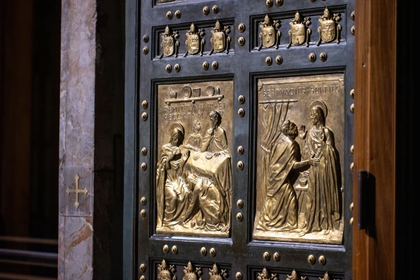 Detail of the bronze panels on the Holy Door of St. Peter's Basilica, highlighted during the nocturnal opening for the Jubilee of Artists, Feb. 16, 2025. Credit: Daniel Ibáñez/CNA