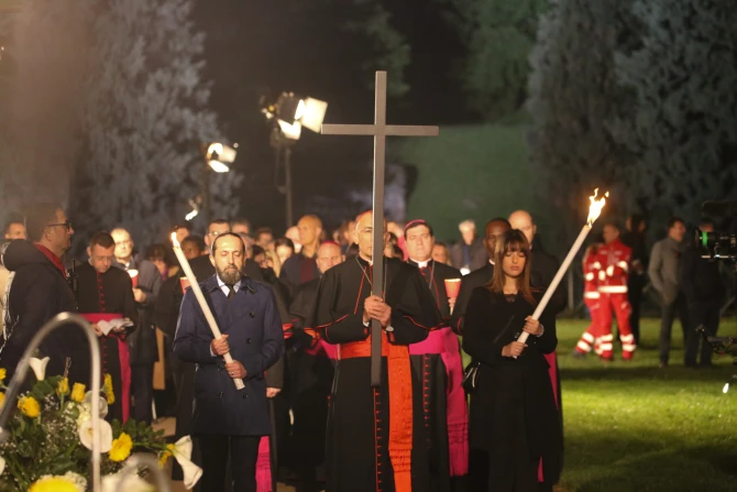 Cardinal Baldassare Reina carries the cross at the Via Crucis procession in Rome on April 18, 2025,