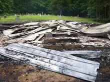 The charred remains of St. Colman Catholic Church in Shady Spring, West Virginia, which was destroyed in a suspected arson attack on Sunday, June 26, 2022.