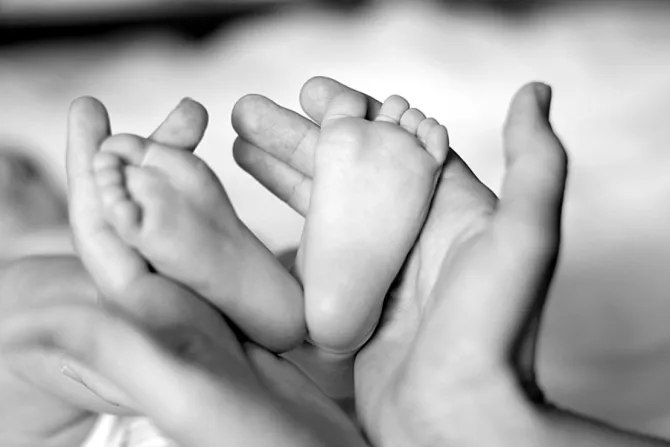 Baby feet in mother’s hands.