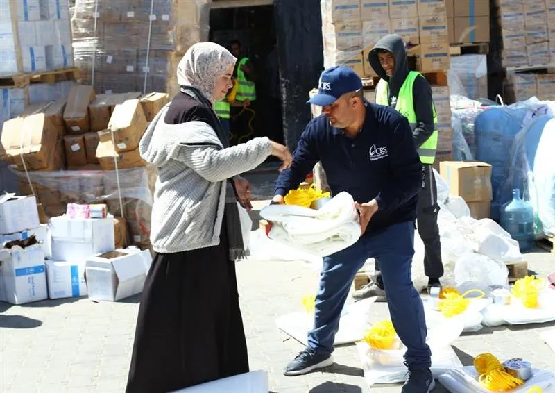 Catholic Relief Services workers help to distribute humanitarian aid materials to Gazan civilians in March 2024.?w=200&h=150