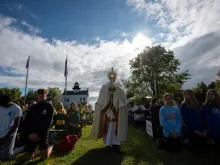 Youth adore Christ in the Eucharist at the "Journey: Why did they come?" youth rally on St. Clements Island, Maryland, Sept. 30, 2023. The altar used during the rally was specially made by local craftsmen to be used for Masses on the island.