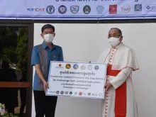 Cardinal Francis Xavier Kriengsak Kovithavanich, Archbishop of Bangkok, turns over the 630-bed isolation facility to Surasak Charoensirichot, governor of Nakorn Pathom province, on Aug. 6, 2021.