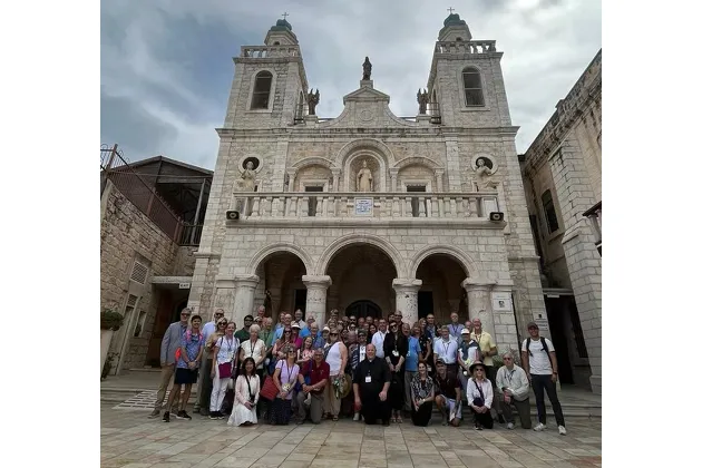 Father Björn Lundberg, center, with the tour group he led to the Holy Land in front of the Wedding Church at Cana.?w=200&h=150