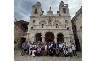 Father Björn Lundberg, center, with the tour group he led to the Holy Land in front of the Wedding Church at Cana. Credit: Bernardo Gonzalez