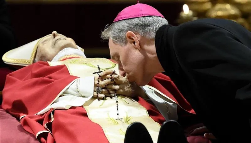 Archbishop Georg Gänswein bent down to kiss the hands of his friend and mentor, Pope Emeritus Benedict XVI.?w=200&h=150