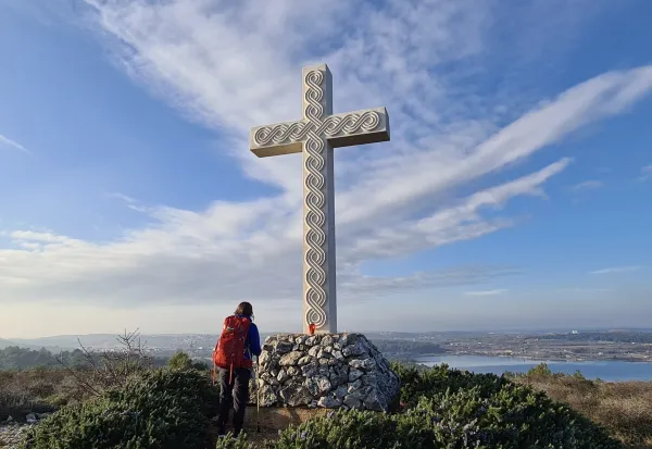 Female pilgrim in front of the cross at Way of the Cross on Camino South Istria, Medulin, Croatia, February 2022. Photo credit: Confraternity of St. James - Croatia