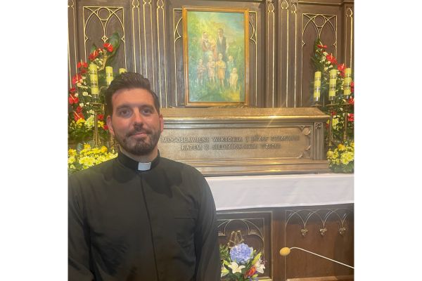 Father Michael Niemczak at the Tomb of the Ulma Family in the parish church of St. Dorothy. Credit: Courtesy of Father Michael Niemczak