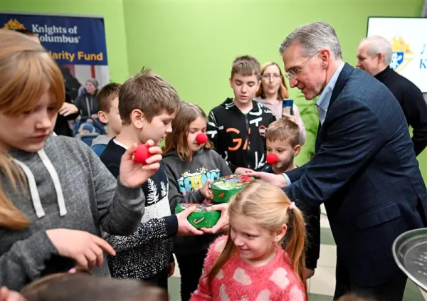 Supreme Knight Patrick E. Kelly gives gifts to children in Lviv, Ukraine, in December 2022. Photo credit: Photo by Andrii Gorb, courtesy of the Knights of Columbus