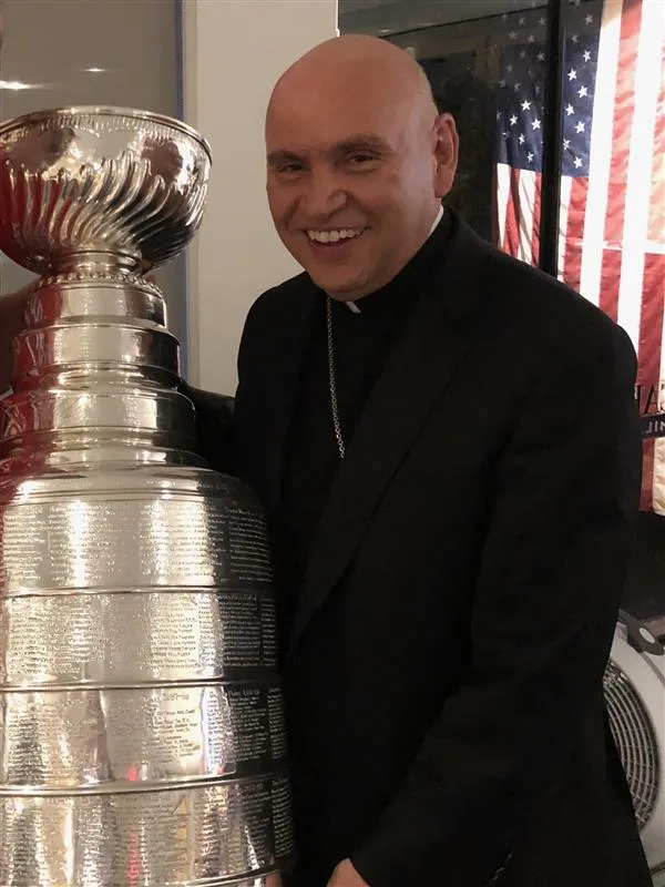 Bishop Dorsonville poses with the Stanley Cup, after his the Washington Capitals won the National Hockey League championship. Credit: Photo courtesy of Steve and Courteney Simchak