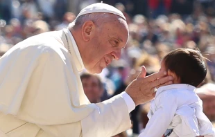 Pope Francis greets a child at a general audience at the Vatican, April 20, 2016. Vatican Media.