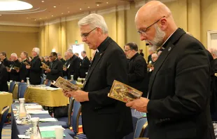 Archbishop Paul Coakley of Oklahoma City (Left) and Bishop James Wall of Gallup (Right) pray before the afternoon session of the 2019 USCCB General Assembly, June 12, 2019. Kate Veik/CNA