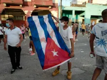 A man waves a Cuban flag during a demonstration against the government of Cuban President Miguel Diaz-Canel in Havana, July 11, 2021.