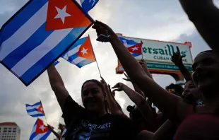 People demonstrate, some holding Cuban flags, during a protest against the Cuban government at Versailles Restaurant in Miami, on July 12, 2021. - Havana on Monday blamed a US "policy of economic suffocation" for unprecedented protests against Cuba's communist government as Washington pointed the finger at "decades of repression" in the one-party state. Credit: Eva Marie Uzcategui/AFP via Getty Images. 