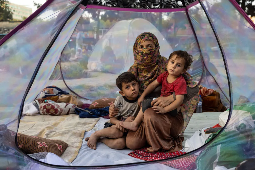 An Afghan mother and her children rest in a tent at a makeshift IDP camp in Share-e-Naw park in Kabul.?w=200&h=150