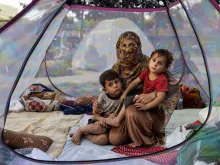 An Afghan mother and her children rest in a tent at a makeshift IDP camp in Share-e-Naw park in Kabul.