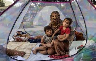 An Afghan mother and her children rest in a tent at a makeshift IDP camp in Share-e-Naw park in Kabul. Paula Bronstein/Getty Images.