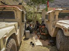 Afghan armed men supporting the Afghan security forces against the Taliban pictured while sitting near their humvee vehicles at Parakh area in Bazarak, Panjshir province, Aug. 19, 2021.