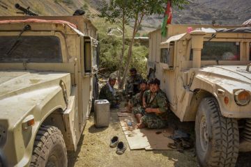 Afghan armed men supporting the Afghan security forces against the Taliban pictured while sitting near their humvee vehicles at Parakh area in Bazarak, Panjshir province, Aug. 19, 2021. Credit: Ahmad Sahel Arman/AFP via Getty Images.