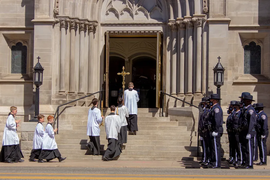 Police officers watch as altar servers enter the Cathedral Basilica of the Immaculate Conception in Denver for the funeral of police officer Eric Talley.?w=200&h=150