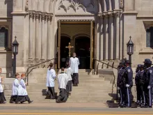 Police officers watch as altar servers enter the Cathedral Basilica of the Immaculate Conception in Denver for the funeral of police officer Eric Talley.