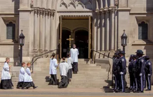 Police officers watch as altar servers enter the Cathedral Basilica of the Immaculate Conception in Denver for the funeral of police officer Eric Talley. Ted Mast.