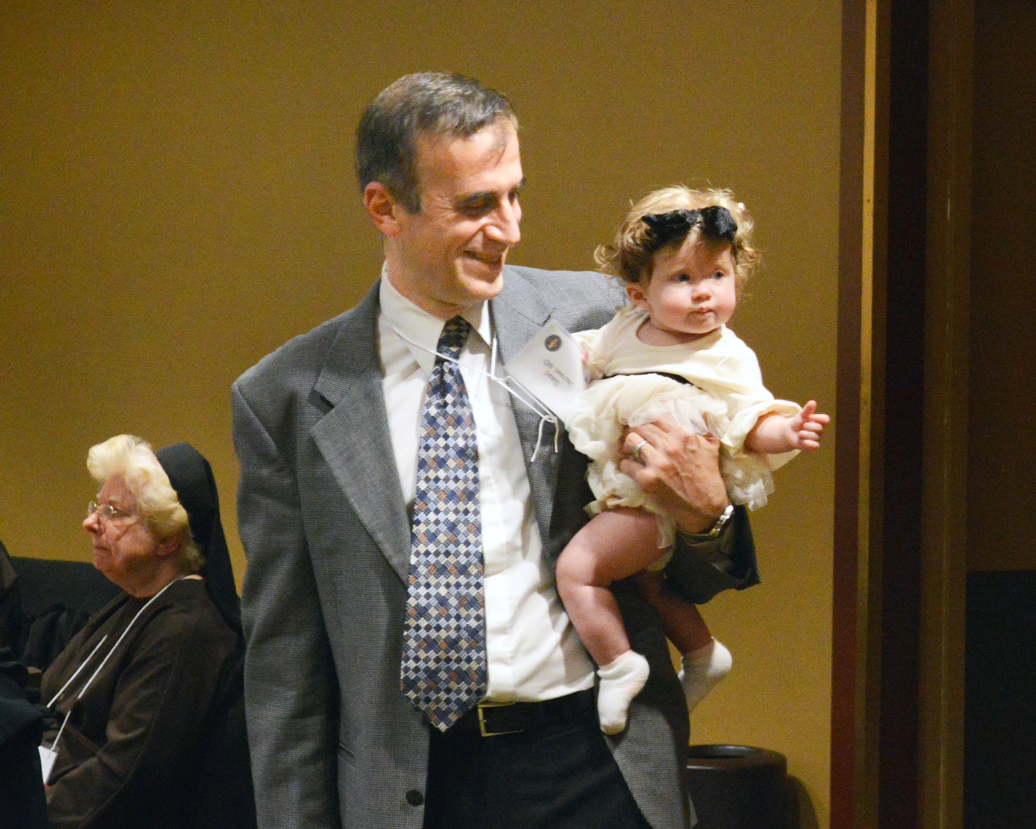 Dr. Saad Jazrawi, president of the Portland Catholic Physicians Guild, holds daughter Samar, age 7 months, during a dinner following the annual White Mass for Catholic health care workers in 2019. “If I combine my faith and my work, I’m a better Catholic and a better physician,” said Jazrawi.?w=200&h=150