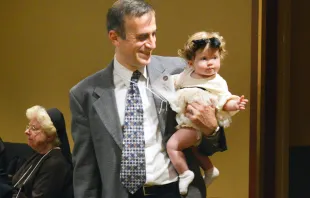 Dr. Saad Jazrawi, president of the Portland Catholic Physicians Guild, holds daughter Samar, age 7 months, during a dinner following the annual White Mass for Catholic health care workers in 2019. “If I combine my faith and my work, I’m a better Catholic and a better physician,” said Jazrawi. Ed Langlois/Catholic Sentinel