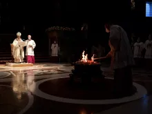 Pope Francis prays before the Easter fire in St. Peter's Basilica on April 3, 2021.