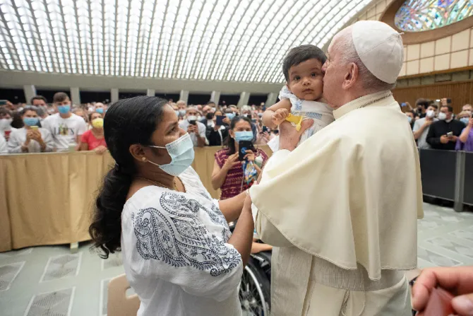 Pope Francis kisses a baby at the general audience Aug. 18, 2021