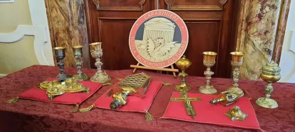 The reliquary with accompanying objects, including a copper cross and six silver chalices. / Courtesy of the Carabinieri Tutela Patrimonio Culturale in Palermo.