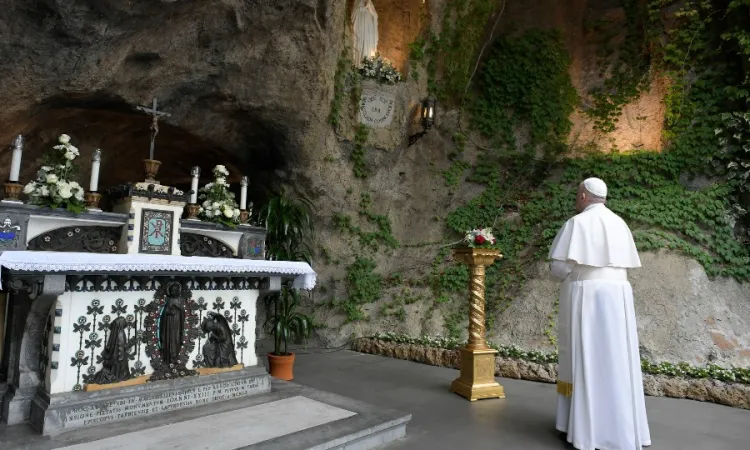 Pope Francis prays at the Lourdes Grotto in the Vatican Gardens May 30, 2020.