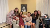 Lisieux House ladies holding up a picture of St. Therese of Lisieux from a feast day celebration they had in her honor.