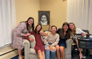 Lisieux House ladies holding up a picture of St. Therese of Lisieux from a feast day celebration they had in her honor. Credit: Photo courtesy of Angela Maccarrone