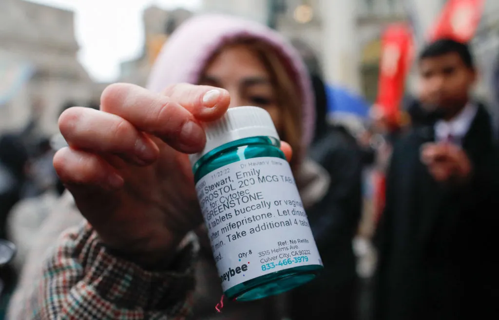 A pro-abortion activist displays abortion pills as she counter-protests during an anti-abortion demonstration on March 25, 2023, in New York City.?w=200&h=150