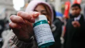 A pro-abortion activist displays abortion pills as she counter-protests during an anti-abortion demonstration on March 25, 2023, in New York City.