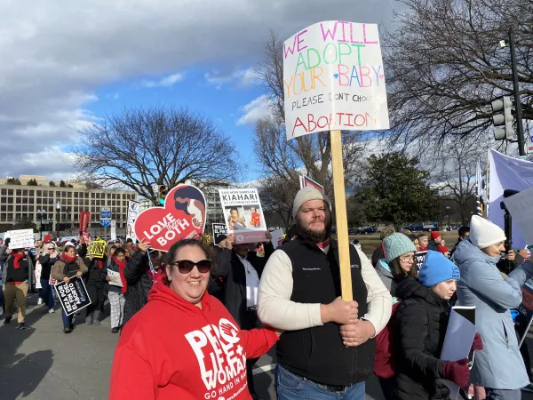 Cameron and Genevieve Mercier from Thompsontown, Pennsylvania, attend the March for Life in Washington, D.C., Jan. 20, 2023. Their sign reads: “We will adopt your baby. Please don’t choose abortion.” Katie Yoder/CNA