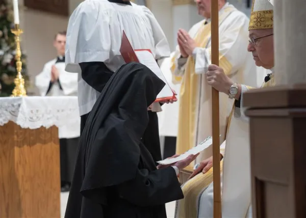 Mother Chiara professing her final vows in the hands of the bishop. Credit: Deborah Kates Photography