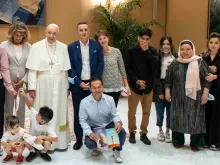 Pope Francis meets with a group of Afghan refugees at the Vatican on Sept. 22, 2021.