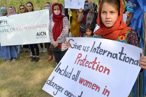 Afghans hold placards as they gather to demand help from the United Nations High Commissioner for Refugees (UNHCR) for asylum abroad, in Islamabad on May 12, 2022. Farooq Naeem/AFP via Getty Images