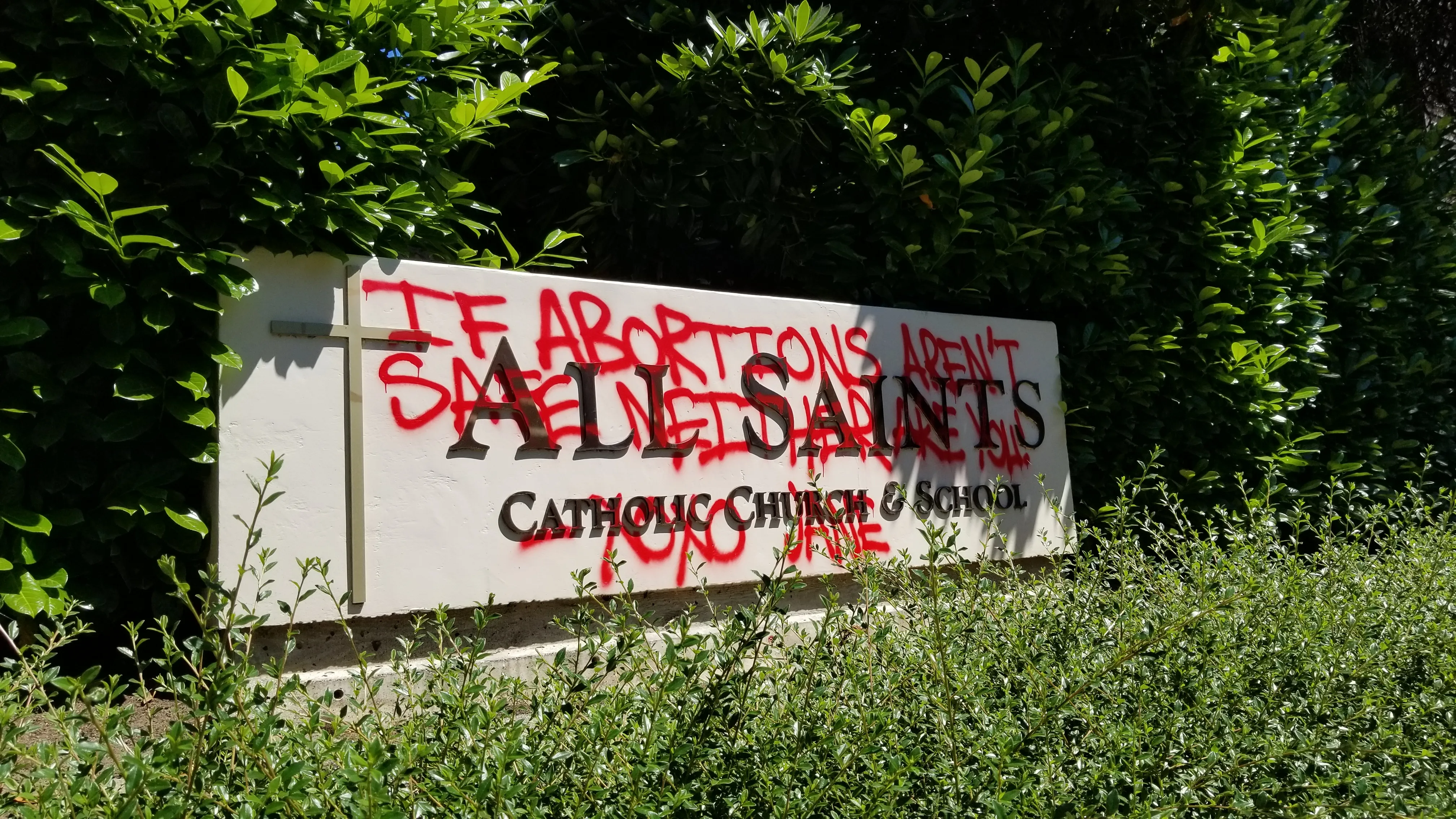 Grafitti on a sign for All Saints Catholic Church in Portland, Oregon, June 25, 2022.?w=200&h=150